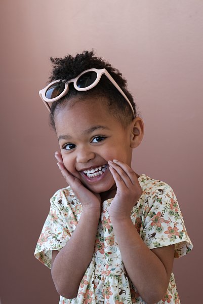 Brand photo of little girl modeling dress and glasses